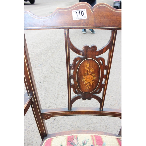 110 - An antique armchair with inlaid back and fabric seat