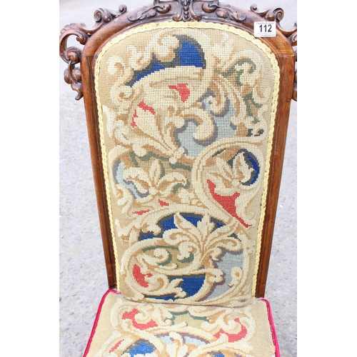 112 - An antique needlework chair with impressive carved details