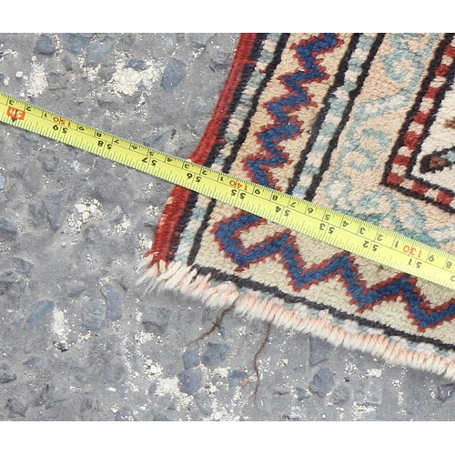 201 - A colourful vintage red and blue ground rug with 3 central medallions and Geometric border