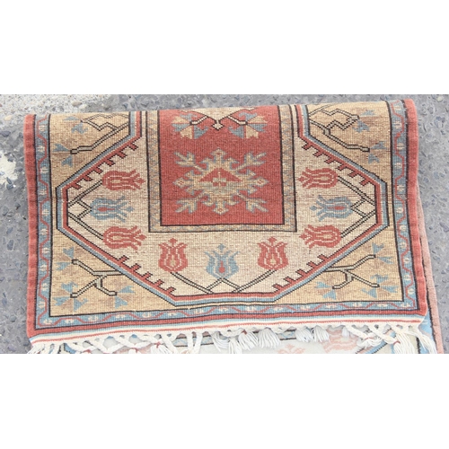 204 - A small vintage wool rug with floral motifs