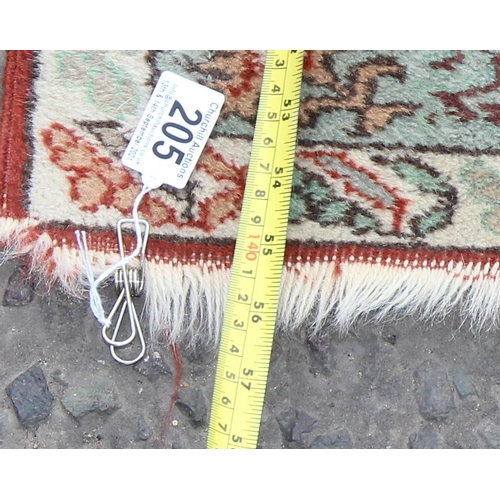 205 - A vintage rug with decorative central panel and profusely decorated borders