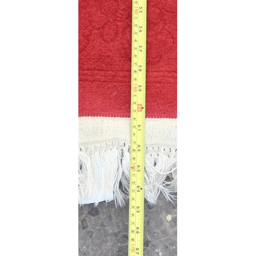 207 - A good quality red ground wool rug