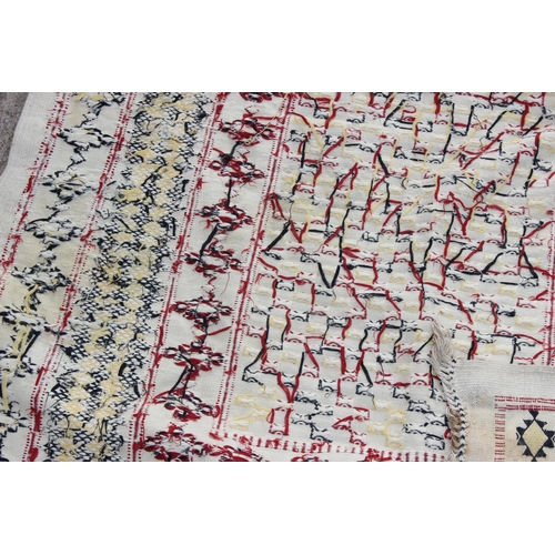 209 - An unusual large flat weave embroidered rug with various geometric borders