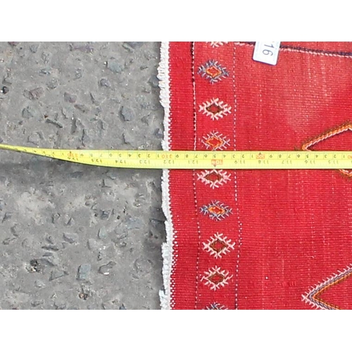 216 - A long red flat weave Kilim runner rug