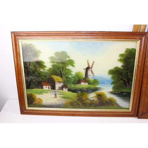 394 - A pair of Victorian reverse painted glass landscape paintings