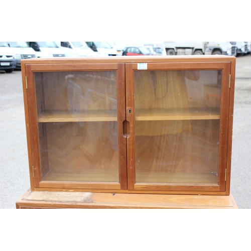 62 - A retro UKAEA Staverton cupboard with glazed bookcase top - dated 1958