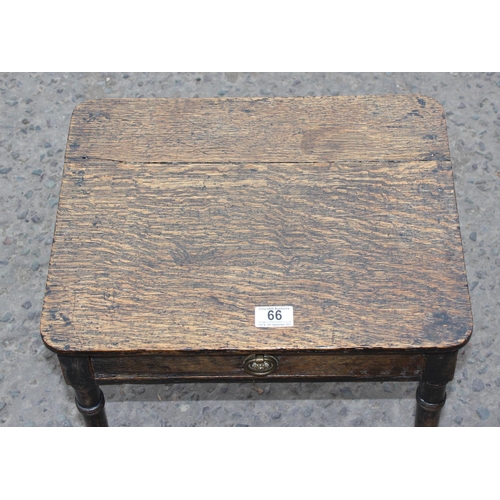 66 - A small antique oak side table with bamboo effect legs and brass and ceramic casters