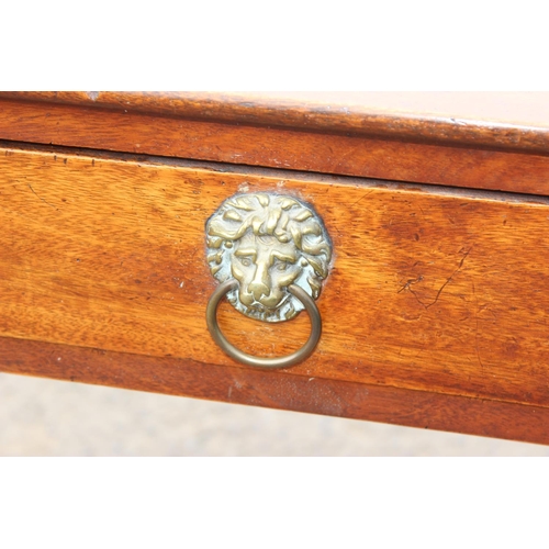 70 - A Victorian mahogany desk with drawer and lion head handles