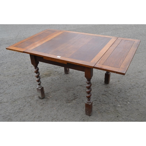 29 - An Art Deco period oak extending dining table on Barleytwist supports