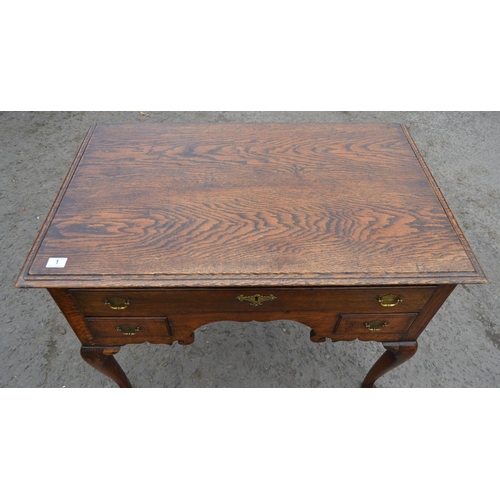 1 - A Georgian oak lowboy with one long drawer over 2 smaller drawers, all with brass fittings, standing... 