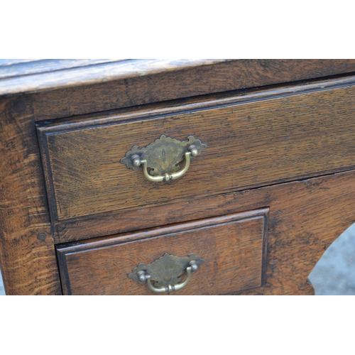 1 - A Georgian oak lowboy with one long drawer over 2 smaller drawers, all with brass fittings, standing... 