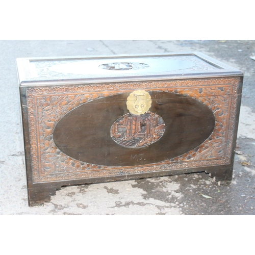 85 - A vintage Oriental carved Camphorwood trunk