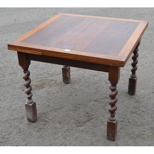 29 - An Art Deco period oak extending dining table on Barleytwist supports