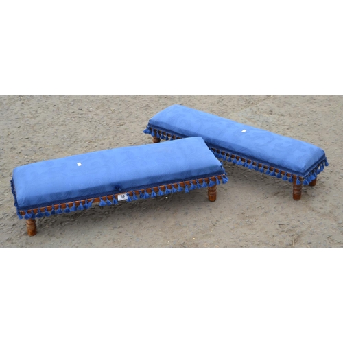 39 - A pair of vintage long low footstools with blue upholstery