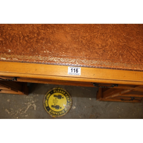 116 - Reproduction leather topped desk with 9 drawers
