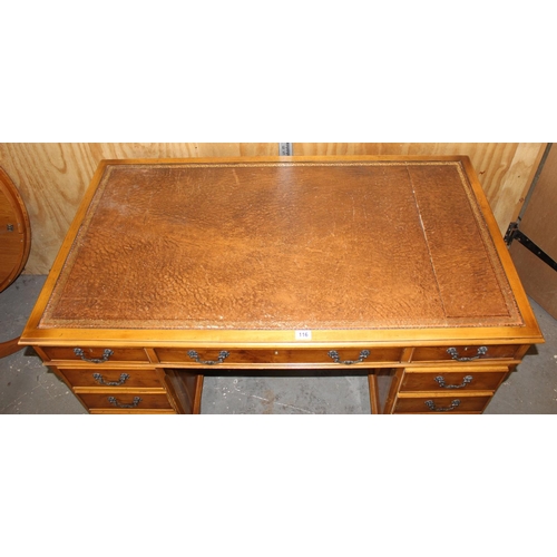 116 - Reproduction leather topped desk with 9 drawers