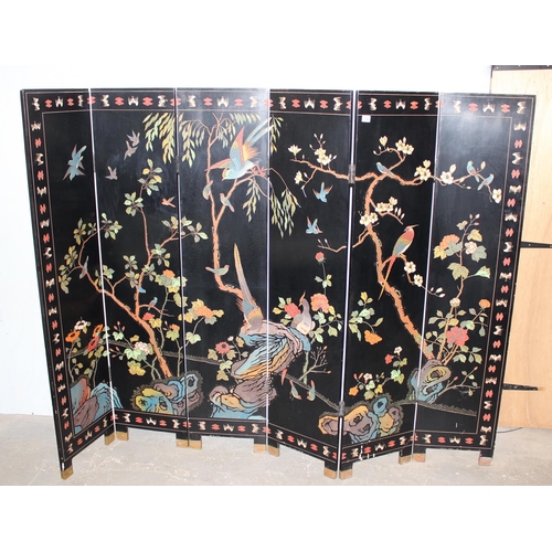 54 - A 20th century Chinese six fold dressing screen, painted or lacquer finish with textured scene of bi... 