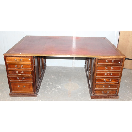 80 - A large Mahogany partners desk with Ox-Blood red leather gilt tooled top