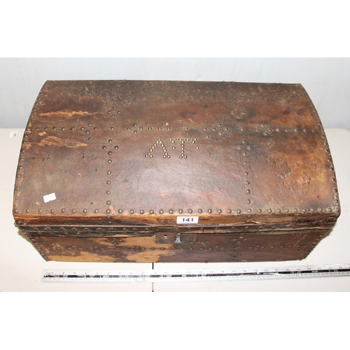 141 - Antique dome topped leather covered trunk with studwork decoration