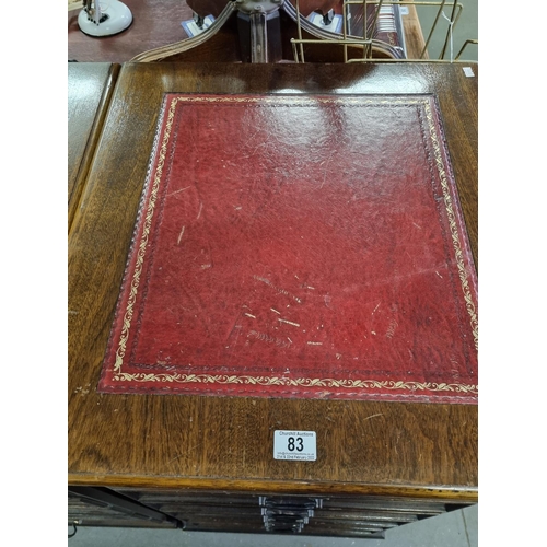 83 - A large pair of Mahogany effect office cabinets with Ox-Blood red leather gilt tooled top