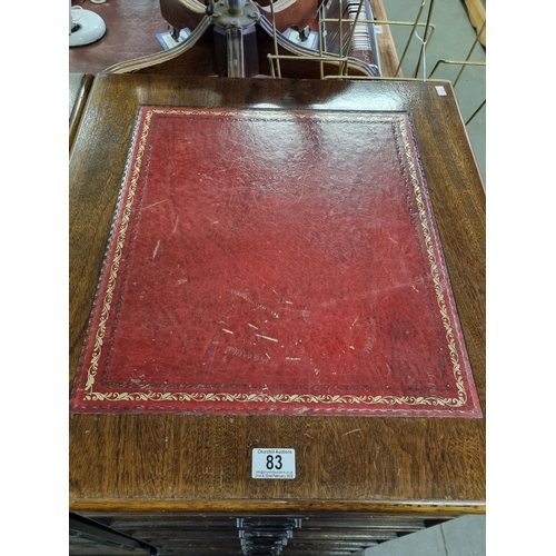 83 - A large pair of Mahogany effect office cabinets with Ox-Blood red leather gilt tooled top