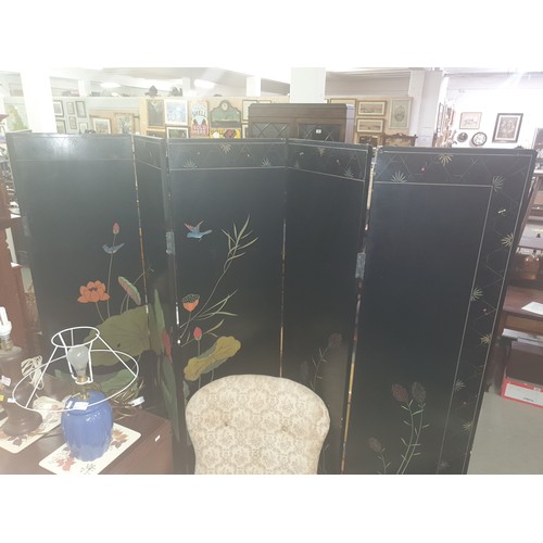 54 - A 20th century Chinese six fold dressing screen, painted or lacquer finish with textured scene of bi... 