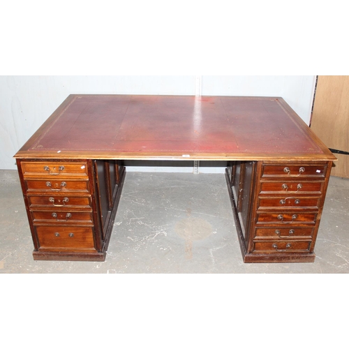 83 - A large Mahogany partners desk with Ox-Blood red leather gilt tooled top