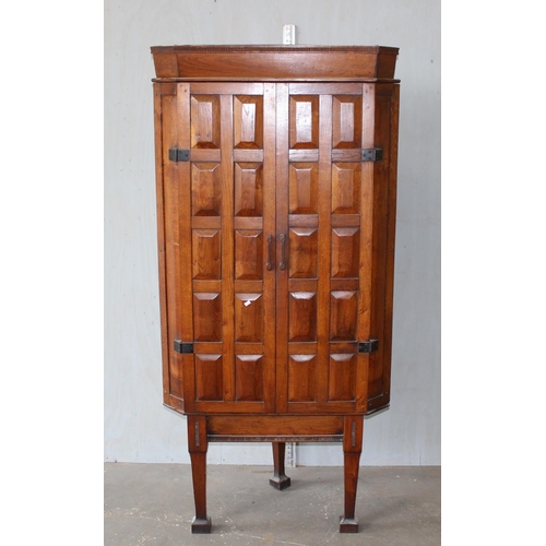 98 - A Georgian style panelled oak cupboard on legs