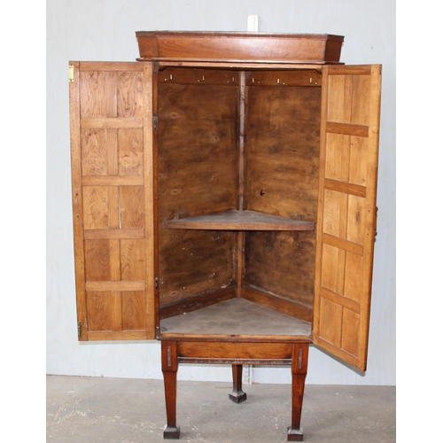 98 - A Georgian style panelled oak cupboard on legs