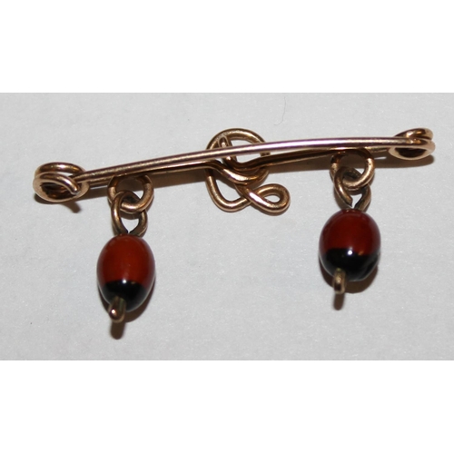 1208 - An early 20th century yellow metal bar brooch formed as a D and 2 unusual hanging droplets, approx 1... 