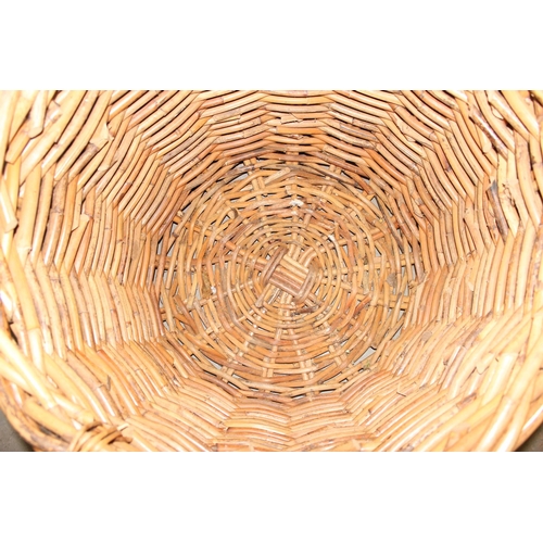 107 - An extremely large vintage wicker log basket with handles, approx 31 inches in diameter and 30 inche... 