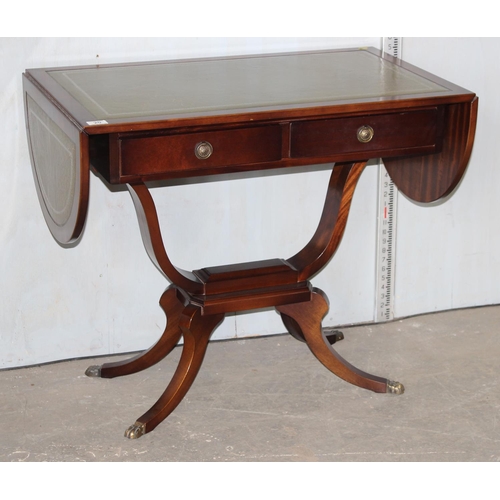 20 - An antique style leather topped dropleaf sofa table