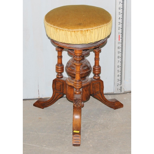 25 - A Victorian mahogany piano stool with screw adjusting top and gold coloured upholstery