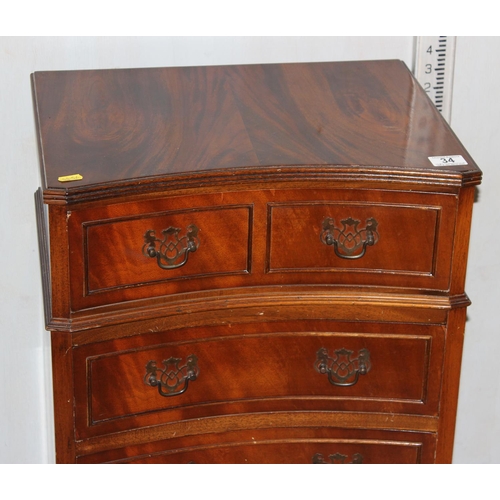 34 - Small 4 drawer mahogany chest of drawers with unusual concave front