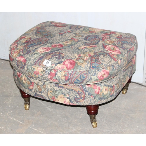 49 - An antique style footstool with Art Nouveau inspired fabric and turned wooden legs with brass cup ca... 