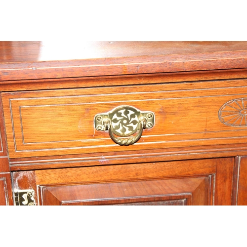 51 - Edwardian mirrored chiffonier with heavily carved panels and doors and a single drawer. Fret work de... 