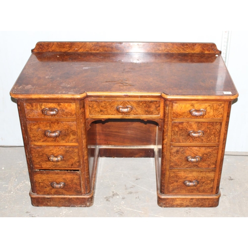 61 - Antique walnut veneered nine drawer desk