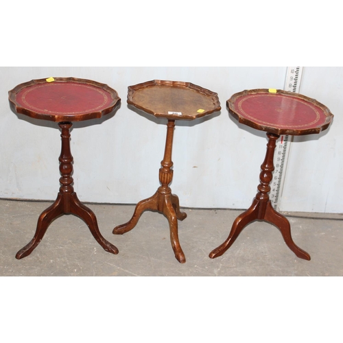 80 - A pair of red leather topped wine tables and another small wine table