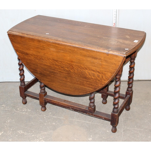 92 - A vintage Oak drop leaf table with barleytwist legs