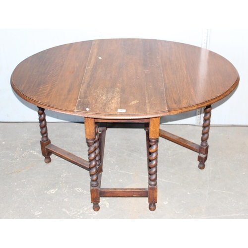 92 - A vintage Oak drop leaf table with barleytwist legs