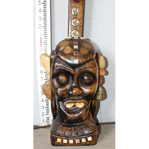 232 - An unusual vintage carved wooden lamp formed as a head inset with stones, coins etc, signed Rojac 19... 