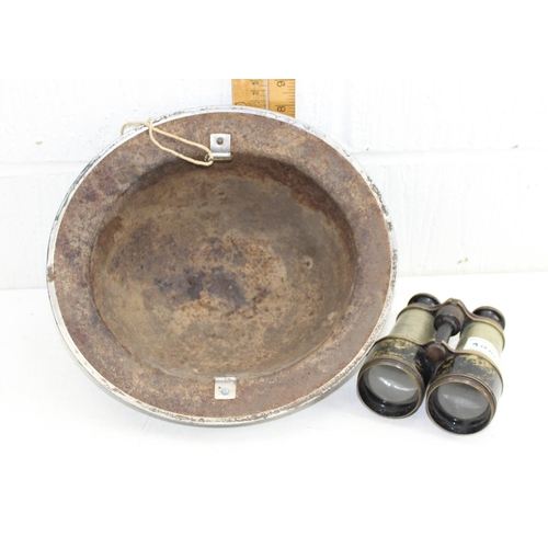 1006 - A WW2 period Brodie helmet, lacking liner and a pair of early 20th century binoculars