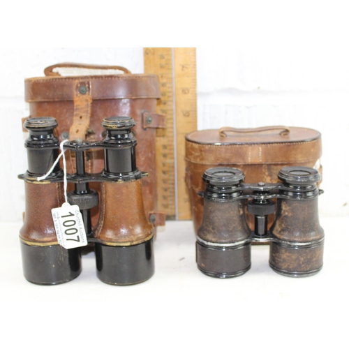 1007 - A pair of WW1 period military binoculars by Tubeue of Paris in leather case and another pair of earl... 