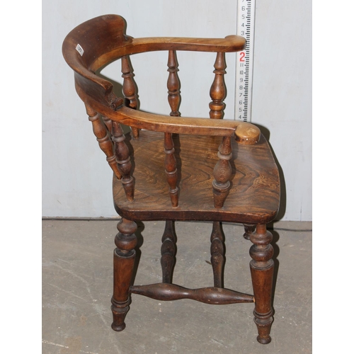 156 - An early 20th century smoker's bow or captain's armchair with elm seat