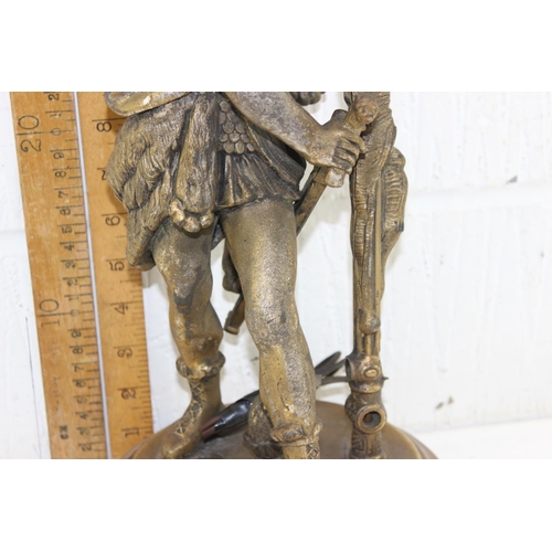 239 - An antique classical style gilded spelter lamp formed as a Roman soldier mearing wolf skin headdress