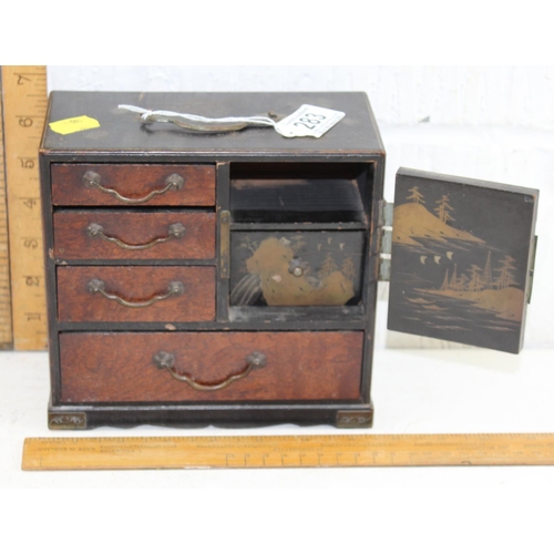 283 - An early 20th century Japanese lacquer table top miniature cabinet with gilt decoration