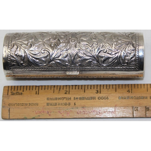 1150 - A cylindrical white metal box with embossed design, various illegible markings, approx 56g gross wei... 