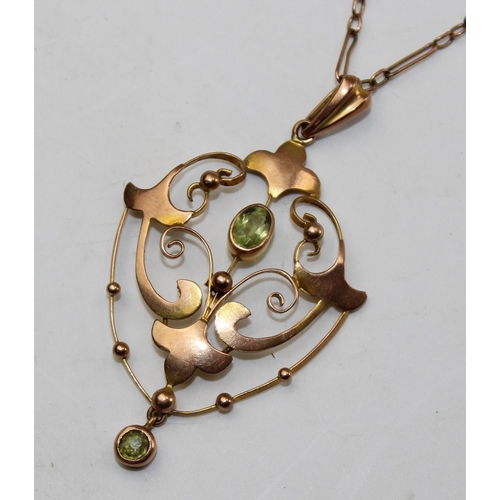 1236 - An Edwardian 9ct gold pendant set with light green stones, likely Peridot, on unmarked yellow metal ... 