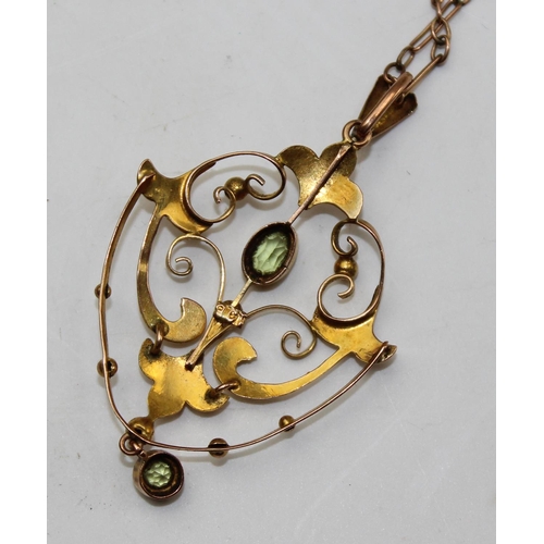 1236 - An Edwardian 9ct gold pendant set with light green stones, likely Peridot, on unmarked yellow metal ... 