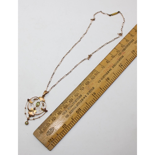 1236 - An Edwardian 9ct gold pendant set with light green stones, likely Peridot, on unmarked yellow metal ... 